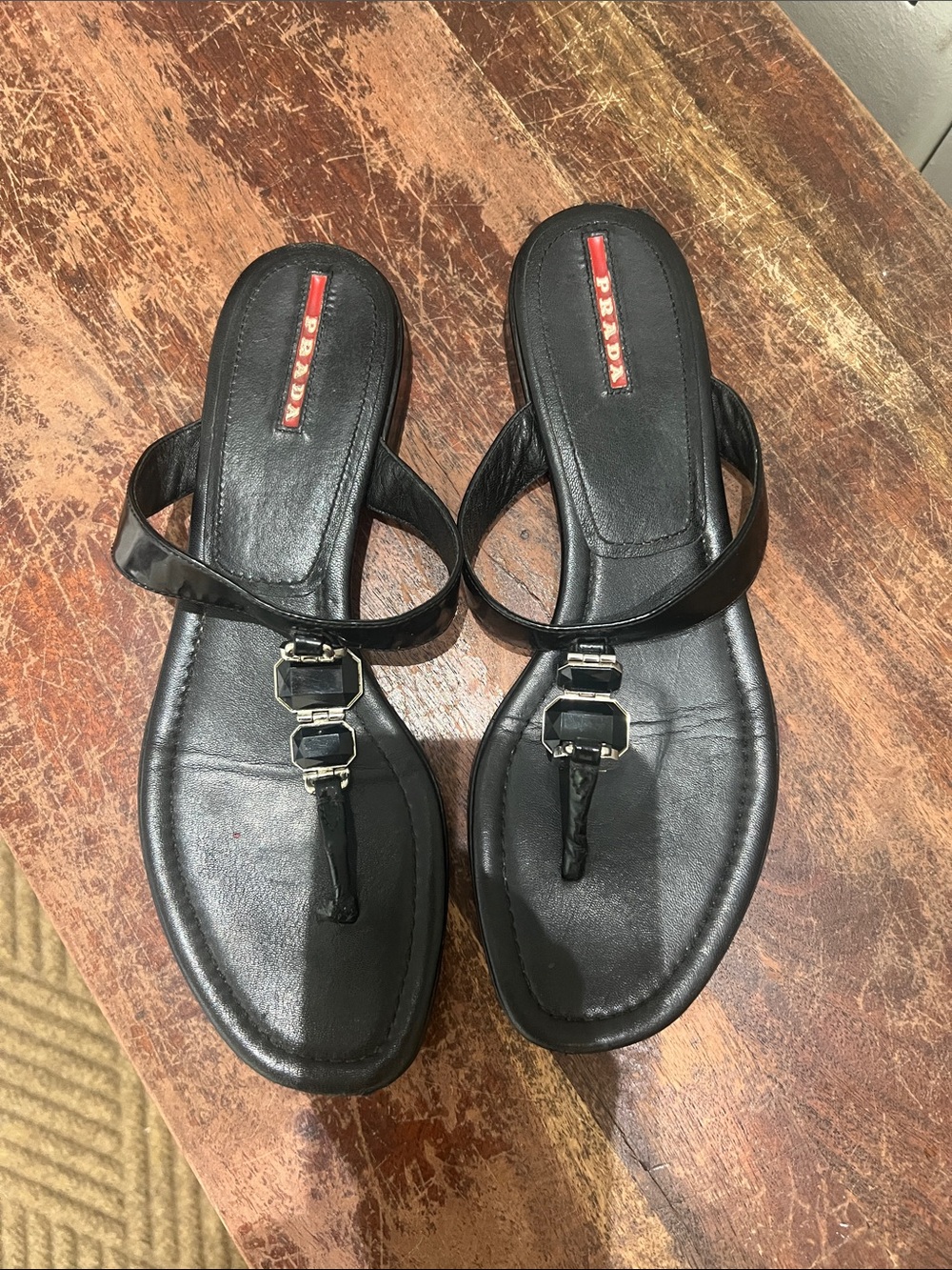 Prada Black Leather T-Strap Sandals with Silver Buckle Accents